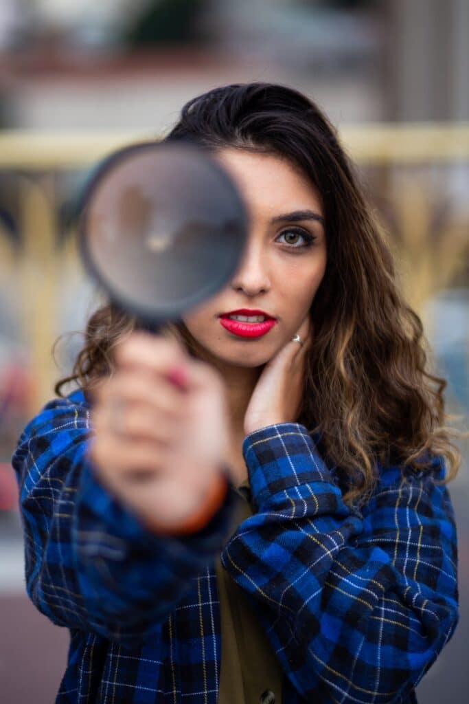 Woman holding a magnifying glass