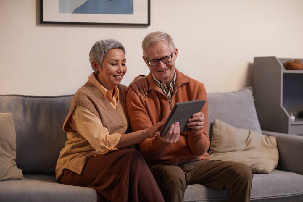 Couple on a couch looking at a tablet